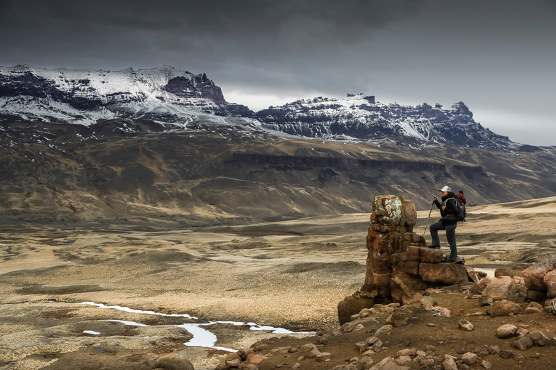visit Patagonia woman resting after trekking.